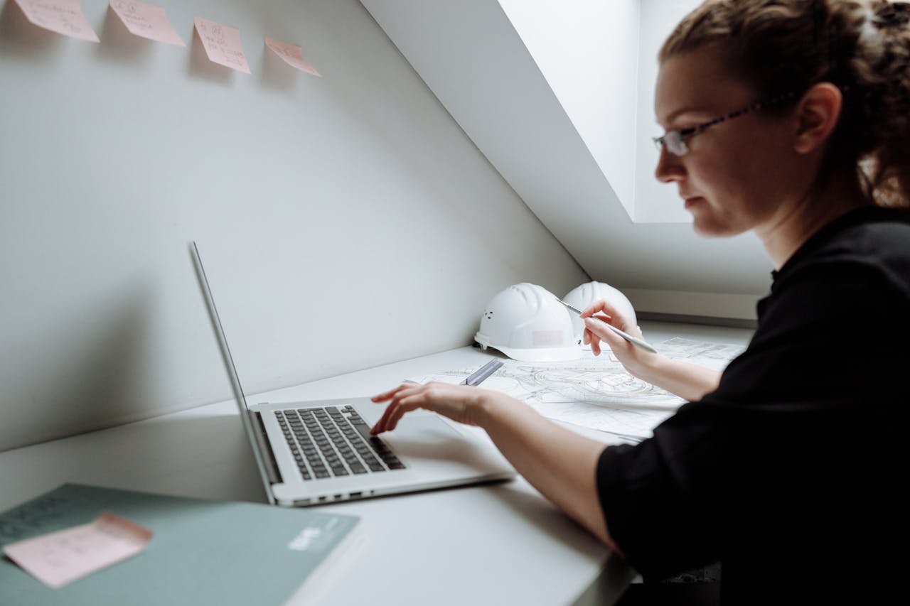 Close-up Photo of Female Architect using Laptop